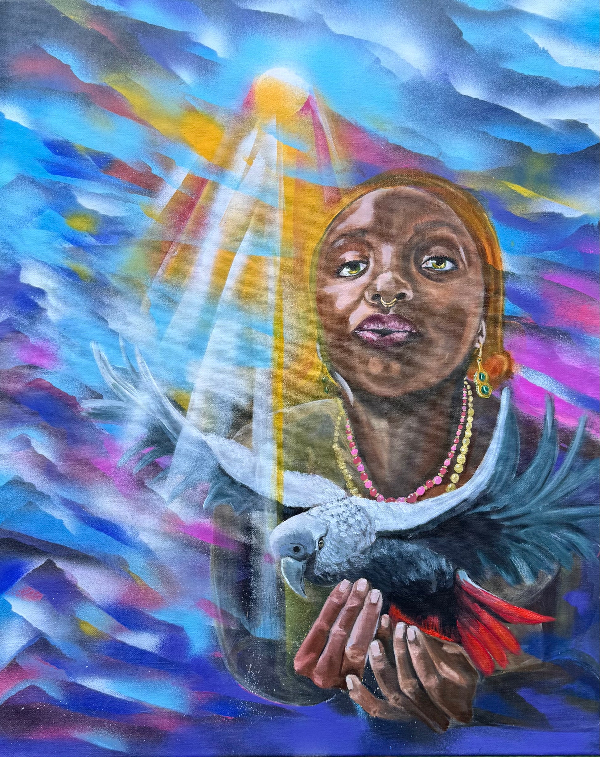 This piece portrays a suspended moment where a contemplative Oya lifts a striking African parrot into shafts of warm light amid a swirl of blues, magentas and gold. The subject’s steady gaze, septum ring and layered beads sit behind the bird’s slate plumage and red tail, creating a charged, intimate dialogue between spirit and wild. Luminous rays carve the haze, revealing soft hands, alert eyes and a tension that is at once tender and ominous—mystery tempered by quiet strength.